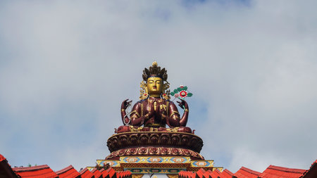 Buddha statue on top of pagoda in Kandy, Sri Lanka