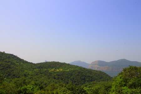View of the forests and hills of the western ghats of Maharashtra, India with hills in the background.の写真素材