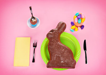A meal made entirely of holiday sweets, featuring an oversized out of scale chocolate Easter bunny.  A visual concept and commentary on overdoing it on the sweets during holidays.   
の写真素材