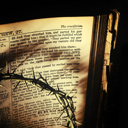 The Crown of Thorns casts dark shadows over an antique 19th century family bible open to St....