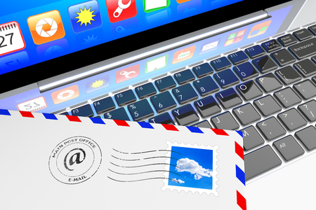 E-mail concept  Envelope letter inbox lying on laptop keyboardの写真素材