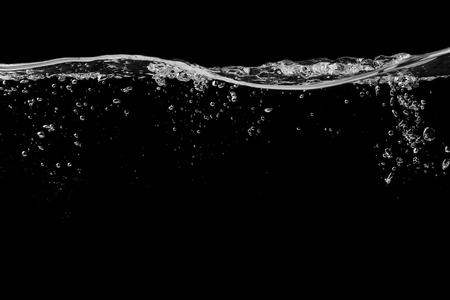 Clear water surface on a black with ripple and bubbles