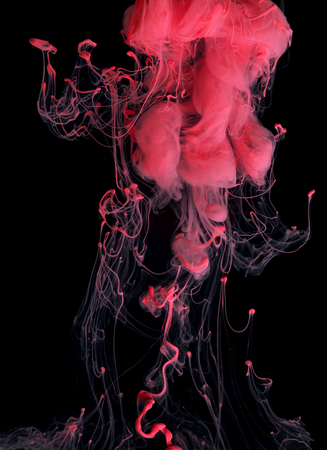 Red color ink paint abstract pattern in water liquidの写真素材