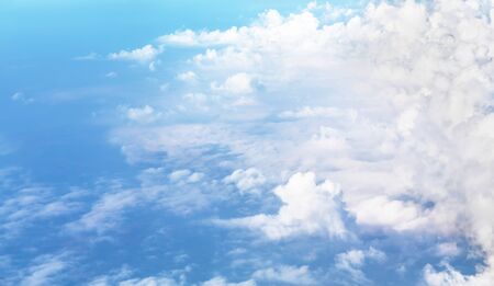 A blue sky cloudscape background with beautiful white clouds shoted from airplane