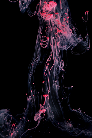 Red color ink paint abstract pattern in water liquidの写真素材