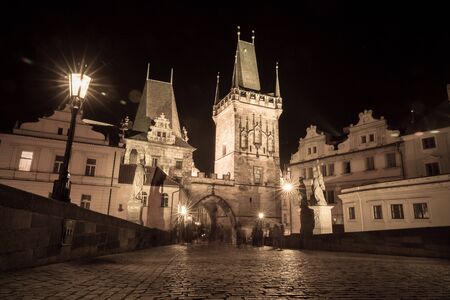 Czech Republic, Prague. Night view of the Charles Bridge in the style of an old photoのeditorial素材