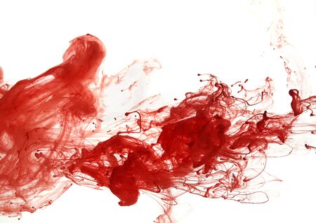 Abstract pattern falling into the water drop of red inkの写真素材