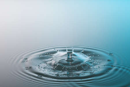 Collision ripple splash of two drops falling into the waterの写真素材