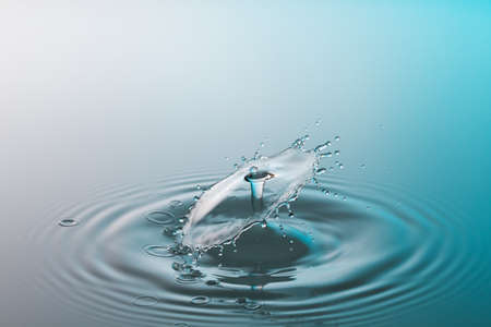 Collision ripple splash of two drops falling into the waterの写真素材