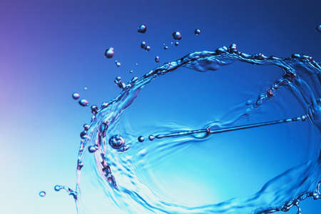Clear water liquid splash on a blue background