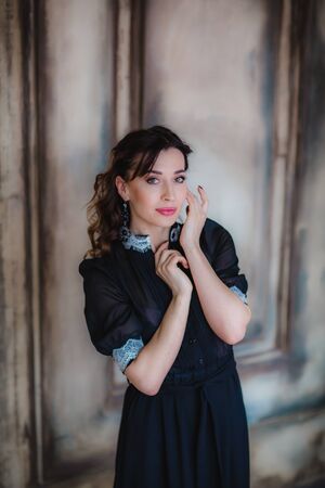 Pretty brunette model posing near art wallの写真素材