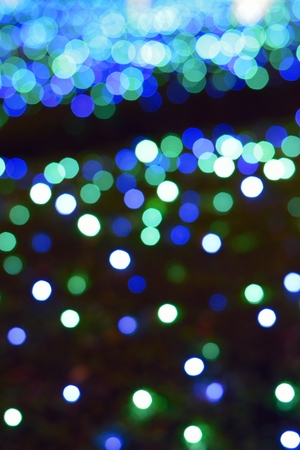 Background texture of blue colored Christmas decoration blurred lightsの写真素材