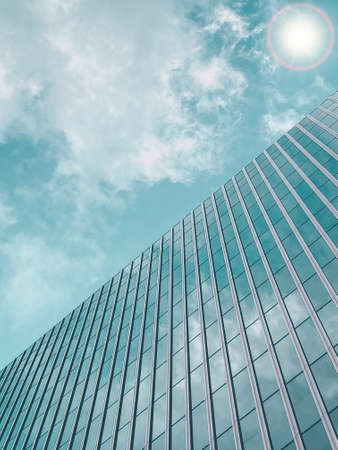 Tall office building in blue sky background with rising cloudsの写真素材