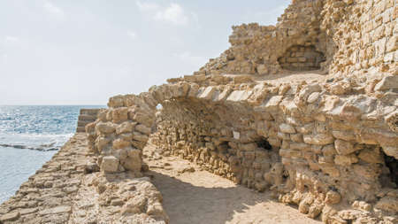 Remains of ancient harbor embankment against Mediterranean Sea background. Acre, Western Galilee region, Israel.の写真素材