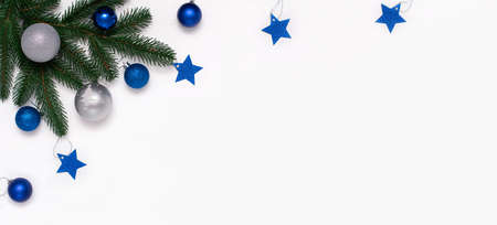 Christmas flatlay with fir branches, blue and silver decorations on white background. Christmas composition, top view, copy space.の写真素材