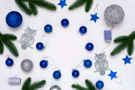 Christmas flatlay with fir branches, blue and silver decorations on white background. Christmas composition, top view, copy space. New Year background.の写真素材