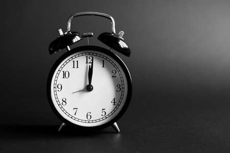 Alarm clock on a black background.の写真素材