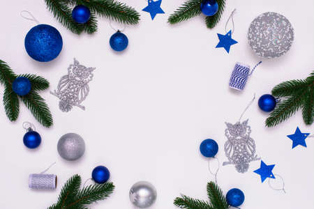 Christmas flatlay with fir branches, blue and silver decorations on white background. Christmas composition, top view, copy space.の写真素材