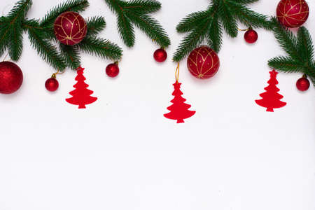 Christmas flatlay with fir branches, red tag on white background. Christmas composition, top view, copy space. New Year background.の写真素材