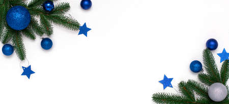 Christmas flatlay with fir branches, blue and silver decorations on white background. Christmas composition, top view, copy space. New Year background.の写真素材