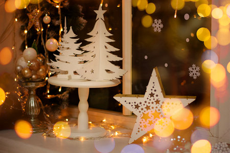 Decoration and christmas concept. Christmas decoration on the window sill. White Christmas. Gold bokeh.の写真素材