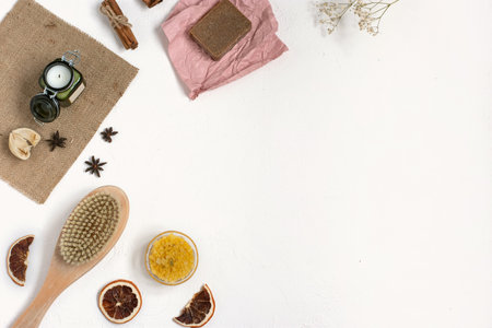 Organic cosmetics. Handemade soap. Flat lay of Body brush, sea salt, coffee, spice, oil on white background. SPA therapy at home.の写真素材