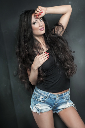 Beauty portrait of attractive young brunette woman with long hair. Looking at camera. Woman posing in the studio. Natural makeup. Surprise happy girl.の写真素材