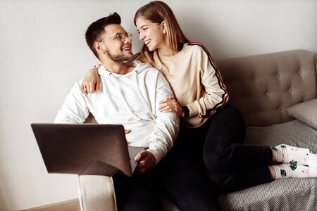 Young couple communicates with family via video communication at home .の写真素材