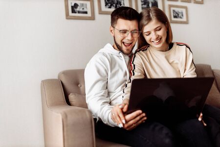 Young couple communicates with family via video communication at home .の写真素材