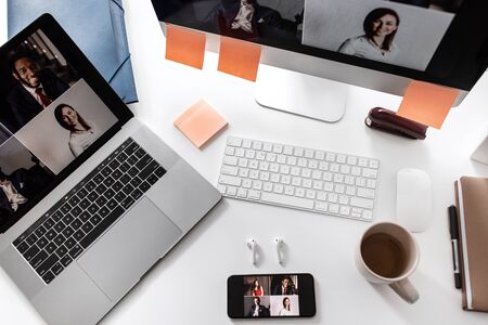 Modern white office desk table with laptop, smartphone and other supplies .の写真素材