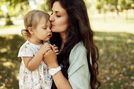 Portrait of amazing mother with cute little daughter walking in the forest. Family concept. ... High quality photoの写真素材