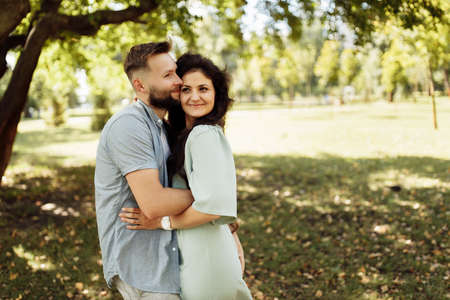 Lovely couple smiling in the garden. Wife and husband holding each other in the beautiful place....