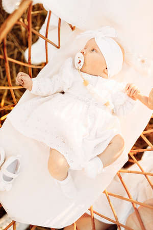 Wonderful newborn baby girl laying in the bed, little child look around with big interest, cute daughter hold mother finger, childhood and motherhood concept. High quality photoの写真素材