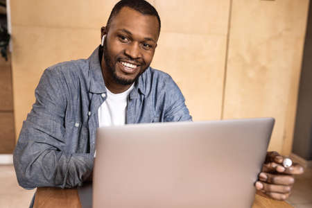 Headshot portrait smiling African American business man making video call, looking at camera, confident positive young trainer leading a remote lesson, businessman participating in online conference.の写真素材