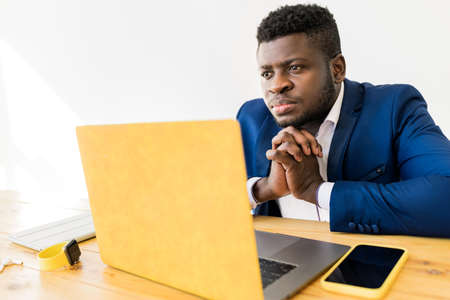 Pensive Afro American male professional freelancer having an online meeting .Concentrated...