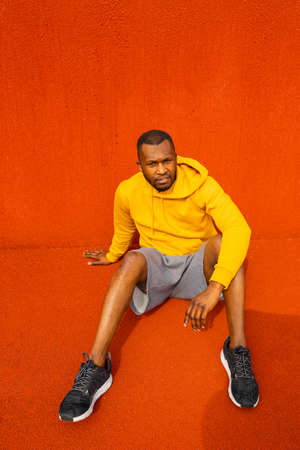 African-American sportsman athlete having break rest after doing sport exercises workout alone....