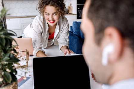 Happy confident colleagues discussing a new project together in modern office, smiling. Successful...