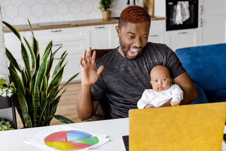 Head shot happy african american mixed race family looking at yellow laptop, holding video call with...