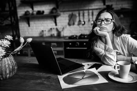Tired business woman working from home with laptop. Busy woman wearing white shirt work from home ....
