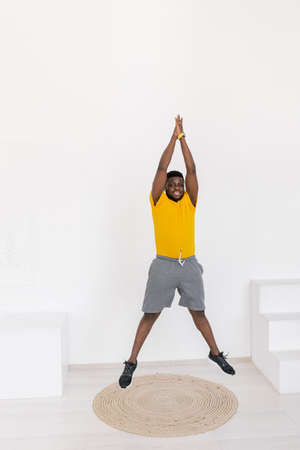 Sporty african american man doing lunges exercises for leg muscle workout training at home alone....