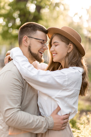 Happy lovely couple hugging in the forest smilling Girl and boy love together Summer time. Large up photo cheerful excited glad careless happy with toothy shining smile attractive woman and with man.の写真素材