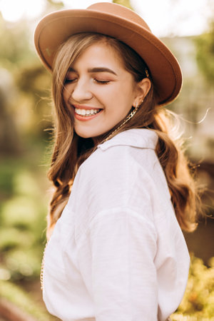 Cute portrait of a girl with a smile with closed eyes in nature. The girl is happy to fly. Happiness and warmth. Concentration of love and kindness in the world. High quality photoの写真素材
