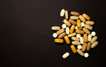 Glutamine and BCAA amino acids. Nutrition for bodybuilding. Fitness supplements on black stone...