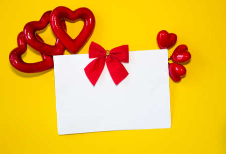 Valentines day congratulation. Red rose and greeting card with heart sign on black background top...