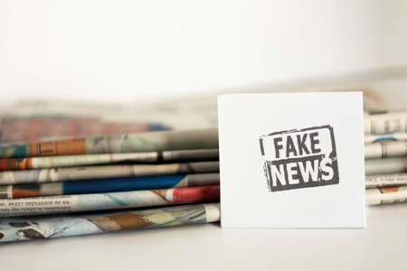 Fake news, disinformation or false information and propaganda concept. . Broken glasses with the inscription.の写真素材