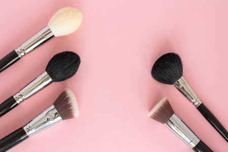 Makeup brushes on a pink background. Top view, flat lay.の写真素材