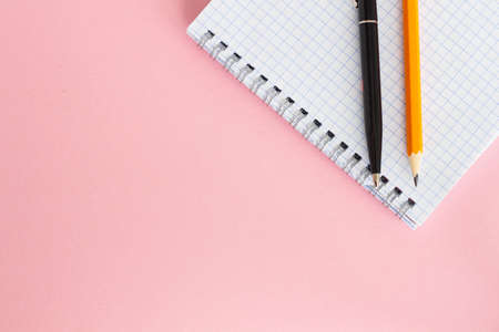 Pencil and notepad on pink background, top view. Space for text