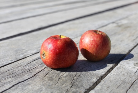 Red apples on wooden backgroundの写真素材