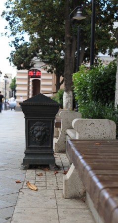 Trash bin on a  pavemnt outdoors の写真素材