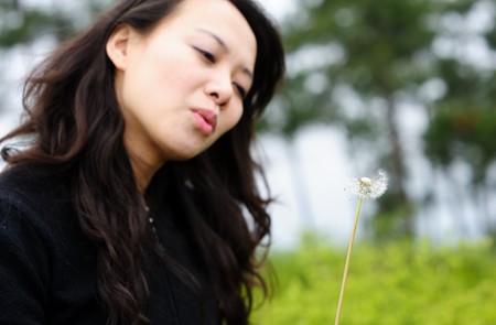 asian woman and dandelionの写真素材